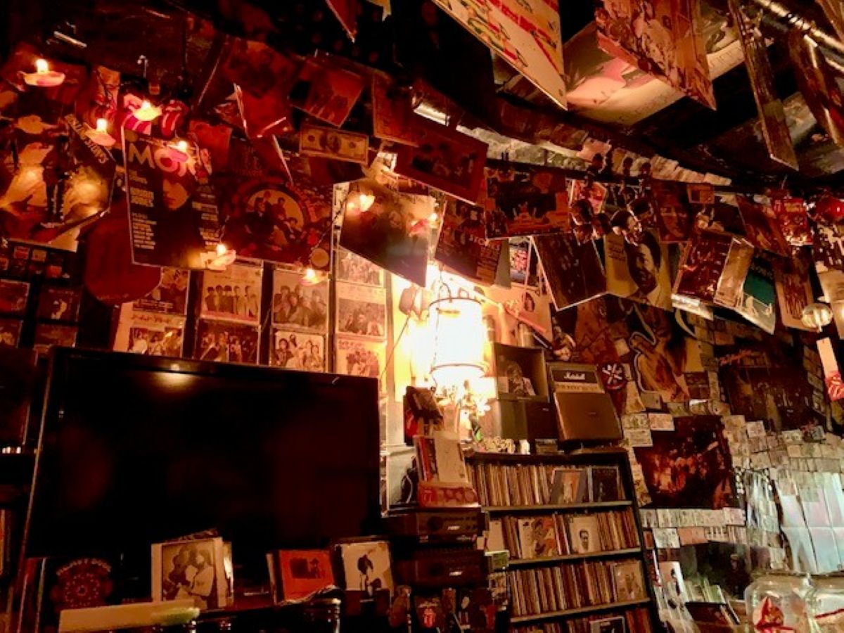 Fanny Mae's Osaka music bar with walls covered in vinyl records, band posters and warm, low light.