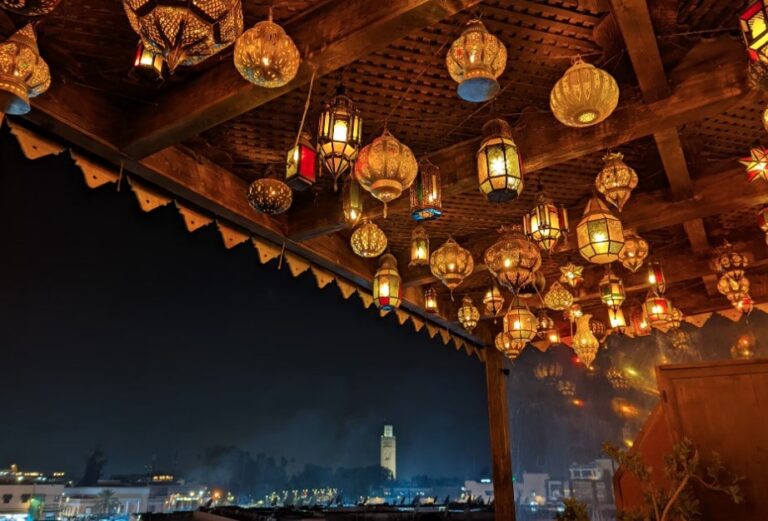 Rooftops at night with lanterns overlooking the square
