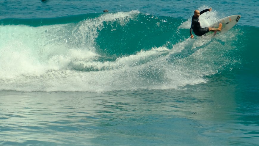 Surfing Beaches Bali: Uluwatu beach Bali surfer on a wave