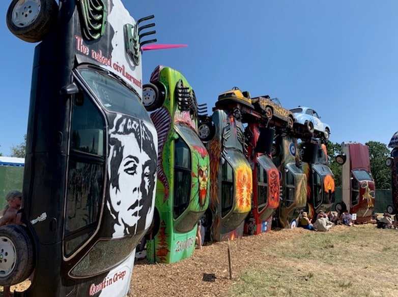 Art installation of cars balanced on their end at Glastonbury Festival