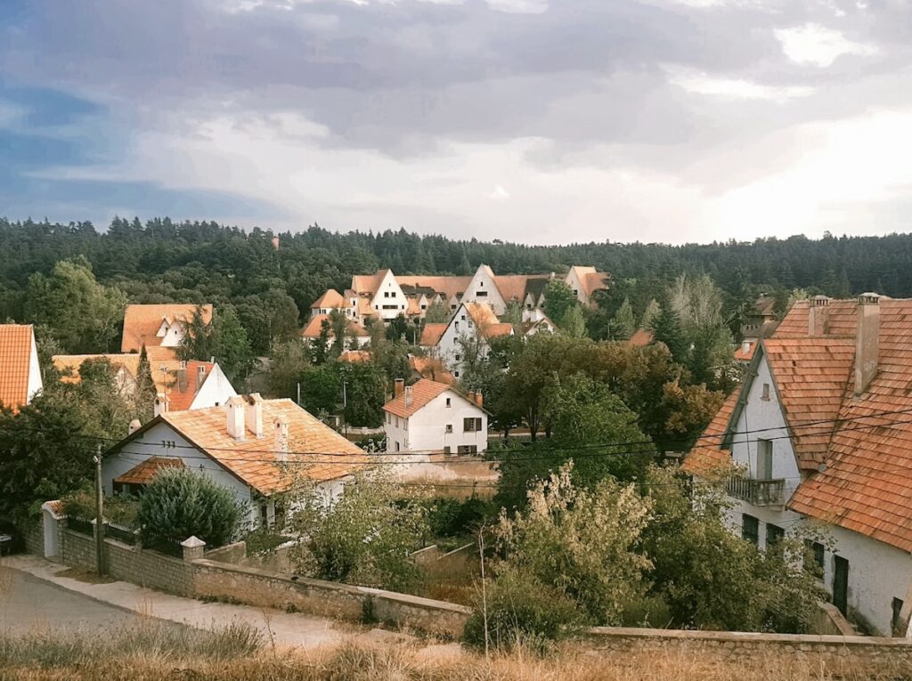 Sloped orange-tiled roofs and white houses of Ifrane, the Alpine-style Moroccan town nicknamed the Switzerland of Morocco