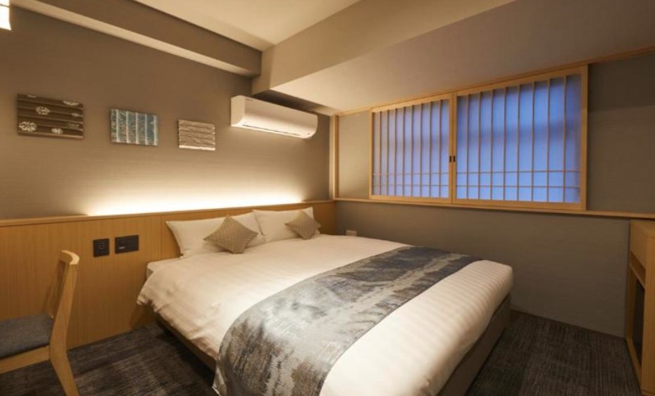 Serene hotel room with traditional shoji window screen, wooden panelling and abstract wall art