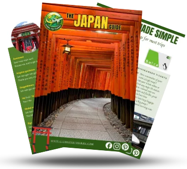 Three pages from the Japan First-Timer Guide fanned out: the orange torii cover, a phrases page, and a transport tips page