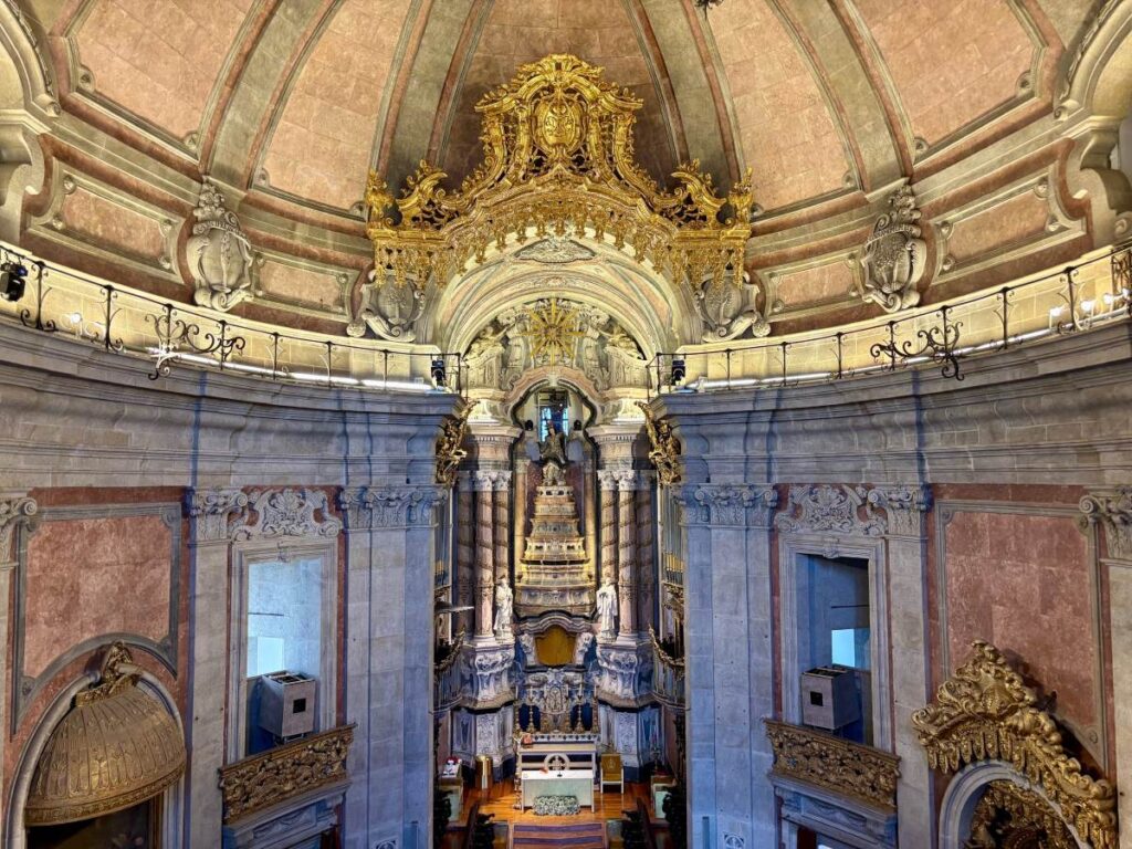 Ornate baroque interior of Clérigos Church with gilded altar, must-see religious architecture during Porto city exploration