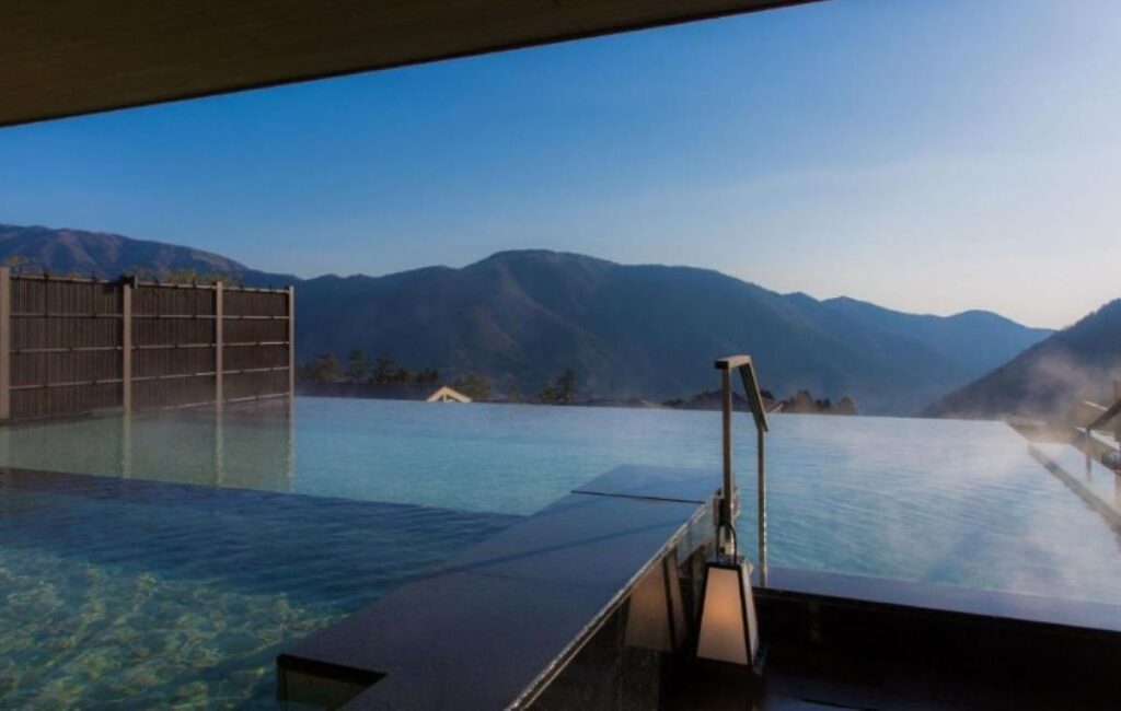 Rooftop onsen with infinity edge and mountain panorama at Hakone hot spring resort