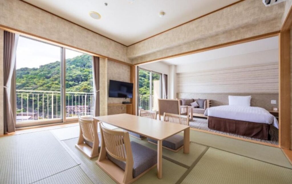 Japanese-Western fusion room with tatami seating area and balcony overlooking Hakone mountains