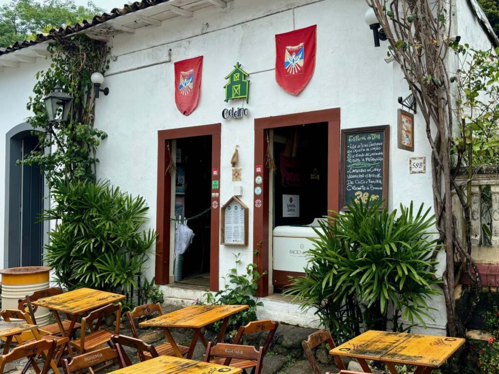 Traditional restaurant entrance with red banners, chalkboard menu and outdoor seating