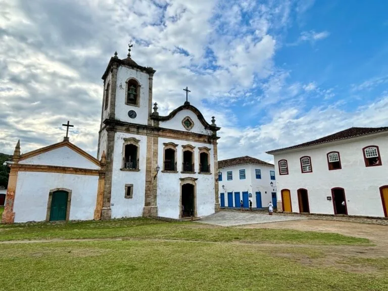 White colonial church with bell tower and cobblestone square in Paraty old town