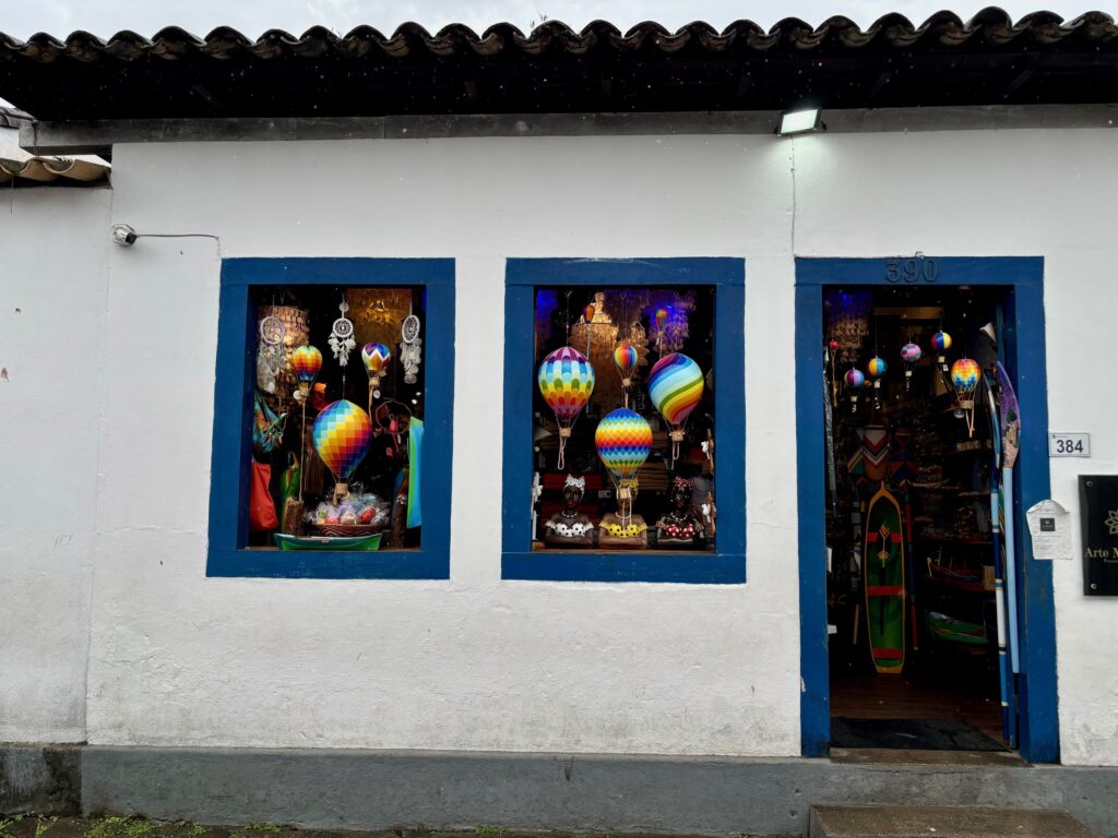 Handicraft shop displaying colourful hot air balloon decorations in blue-framed windows