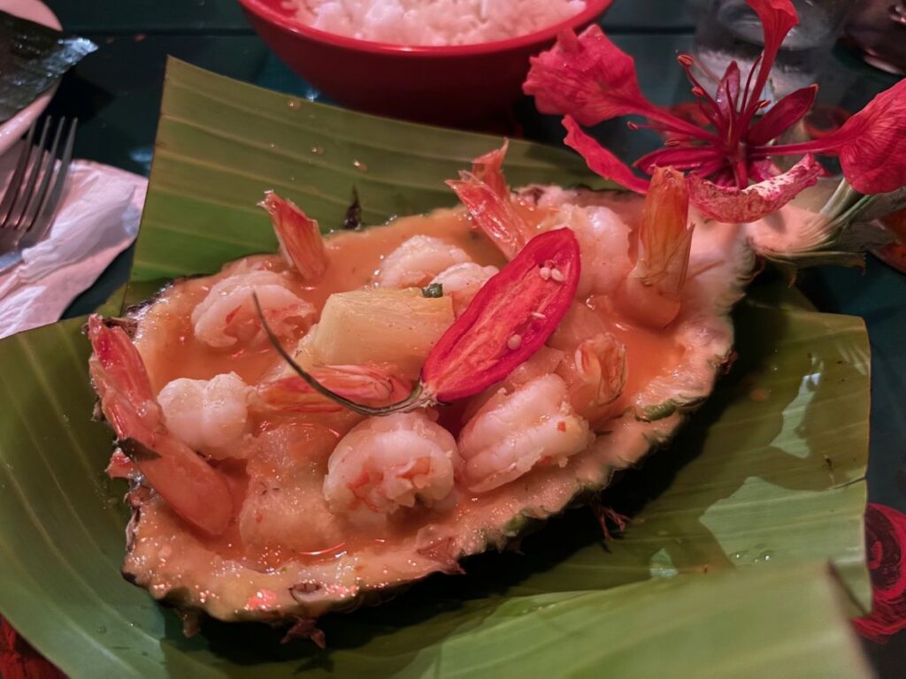 Fresh prawns served on pineapple half with banana leaf presentation