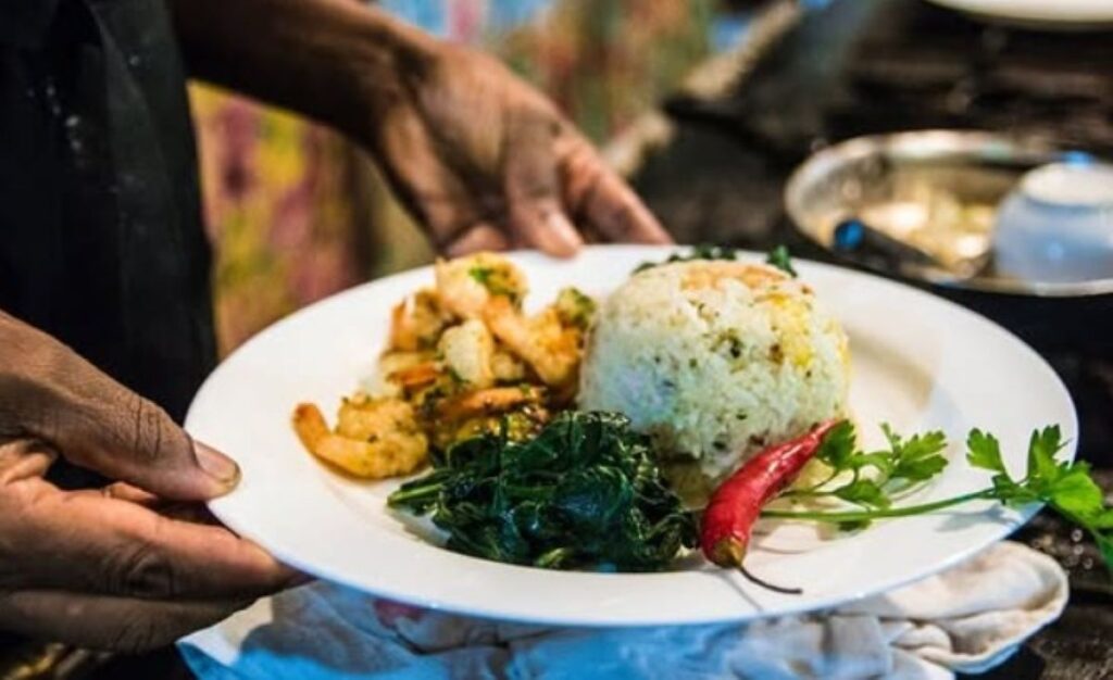 Grilled prawns served with herb rice, sautéed greens and fresh chilli garnish
