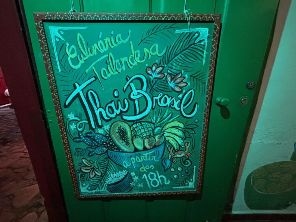 Decorative chalkboard sign for Thai Brazil restaurant with tropical fruit illustrations