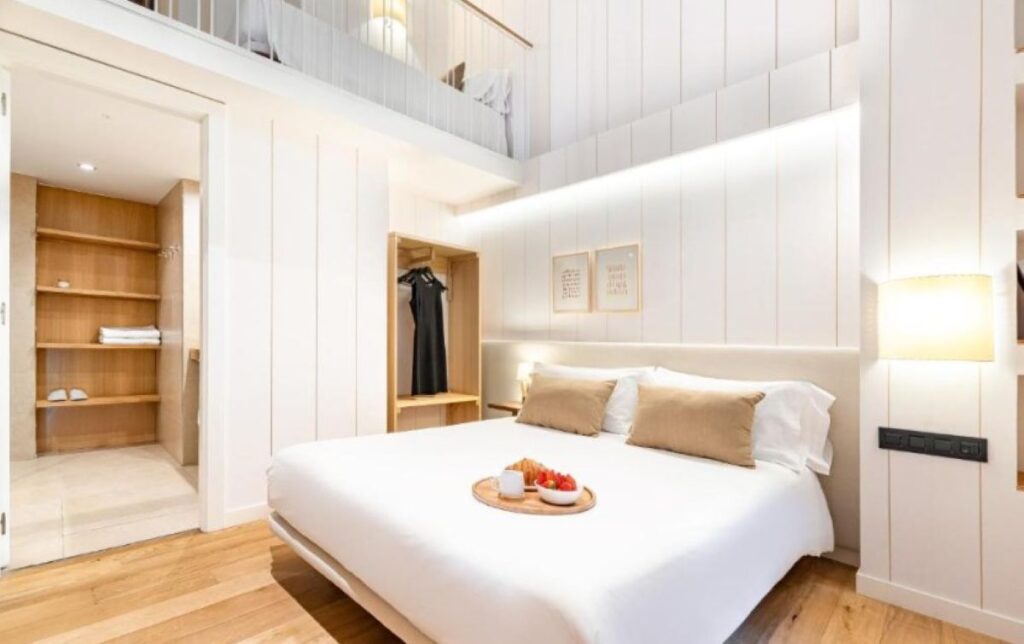 Bright mezzanine apartment with double bed, in-room breakfast tray, open wardrobe and warm timber flooring