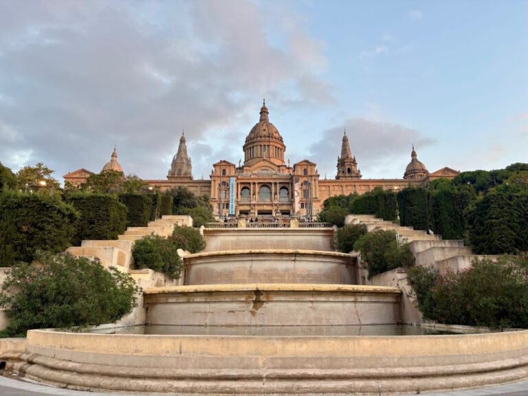 Museu Nacional d’Art de Catalunya seen from the terraces, with grand steps and domed roof at dusk.
