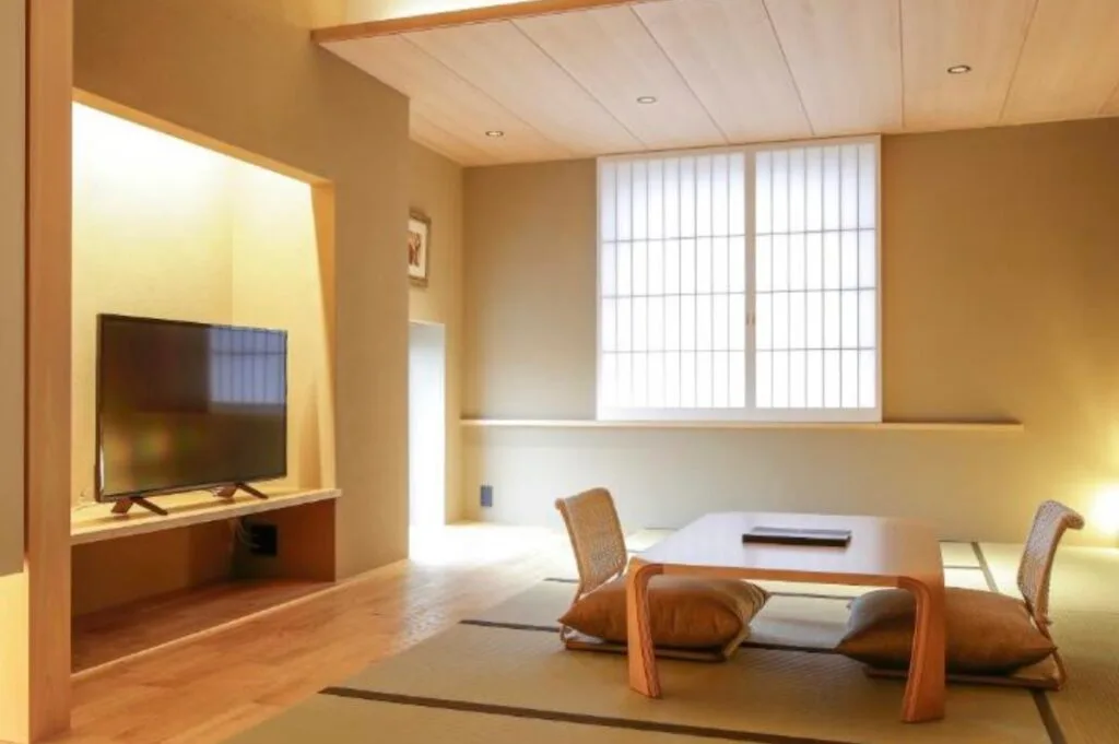 Japanese-style room with tatami flooring, low table and floor chairs at The Gate Hotel Asakusa Kaminarimon