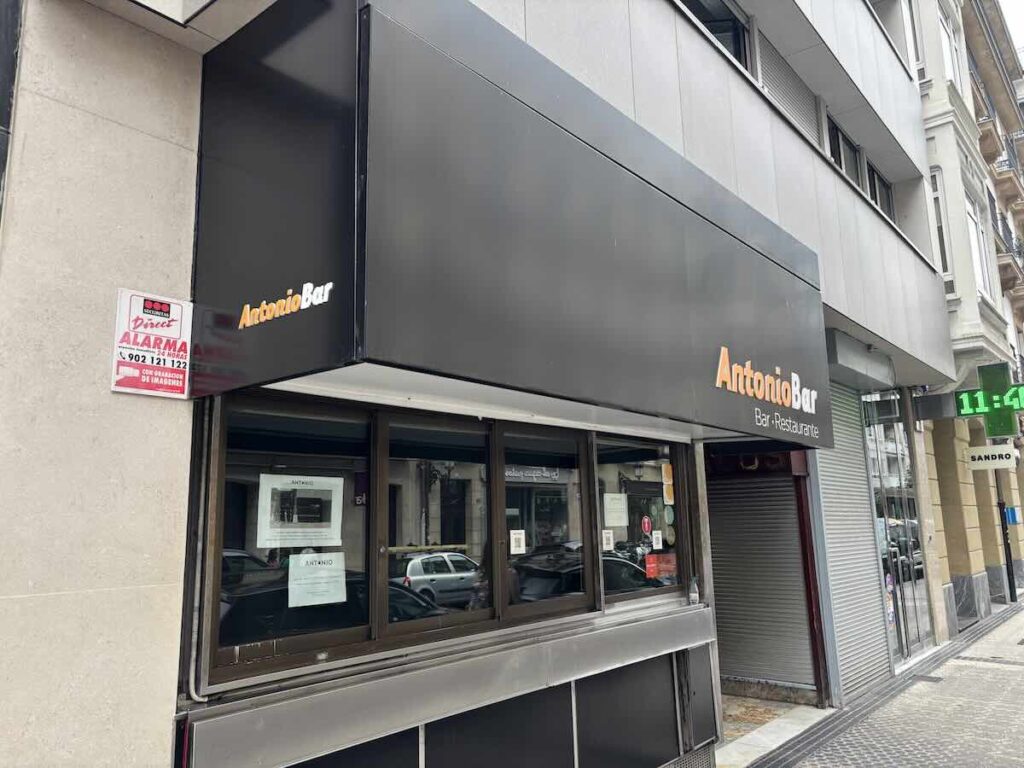 Corner exterior of Antonio Bar with the shutters down in the morning